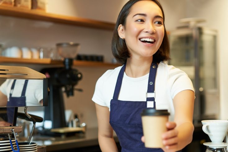 Smiling,Asian,Barista,Girl,,Giving,Takeaway,Coffee,Cup,,Prepare,Takeout